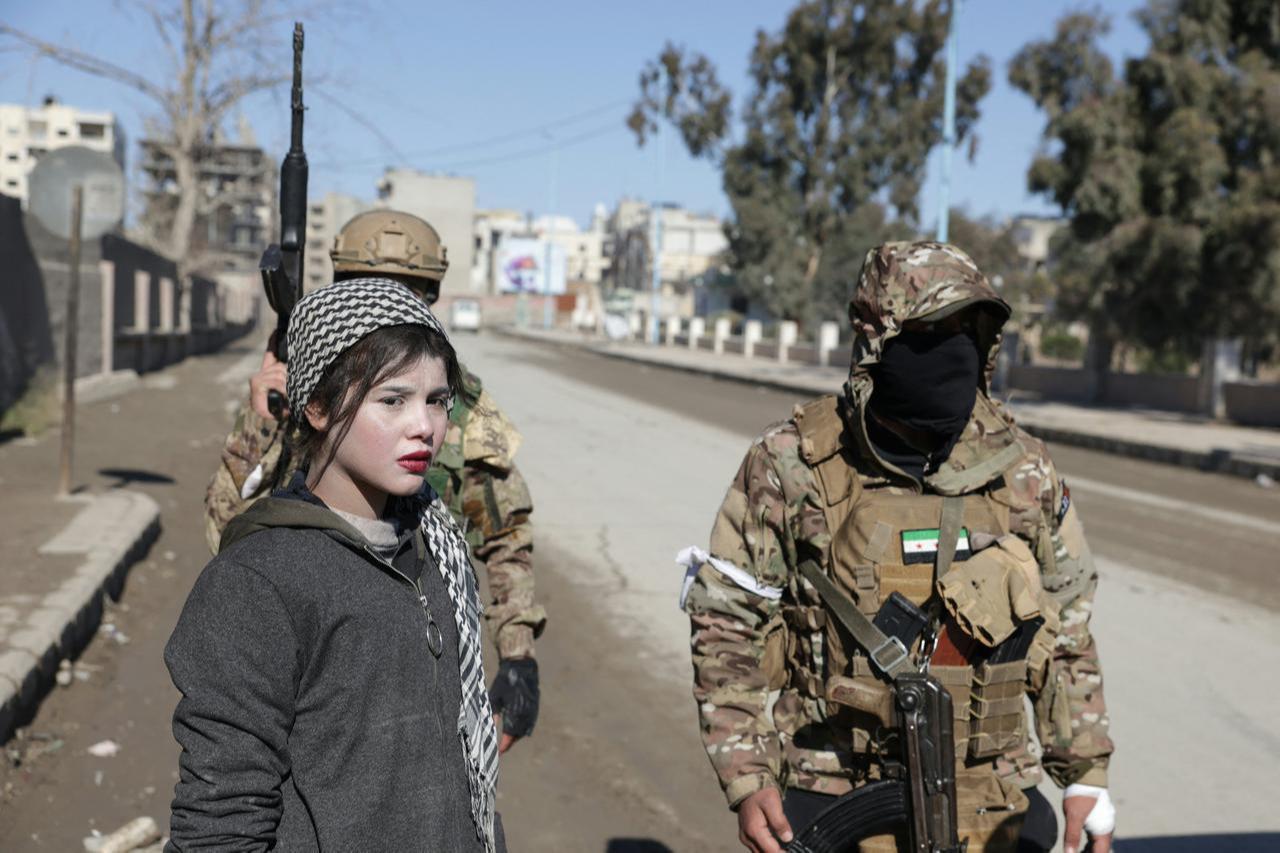 Syrian government forces detain a purported female member of the YPG/SDF as they enter the northern city of Raqqa, Syria, on January 19, 2026. (AFP Photo)