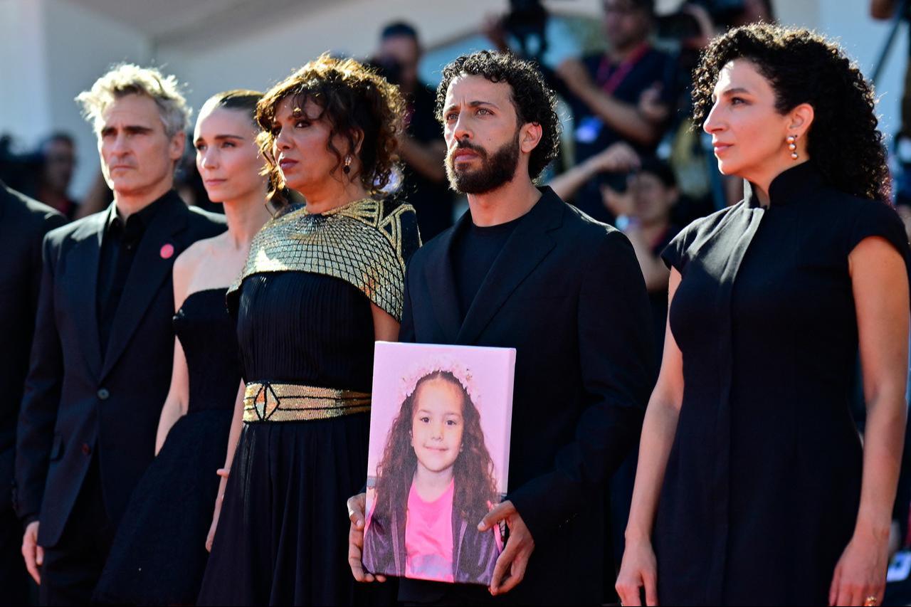 US actor Joaquin Phoenix, US actress Rooney Mara, Tunisian director Kaouther Ben Hania, actor Motaz Malhees, and actress Clara Khoury pose with a portrait of late Palestinian girl Hind Rajab during the red carpet for the movie The Voice of Hind Rajab at the Venice Film Festival, Venice, Italy, Sept. 3, 2025. (AFP photo)