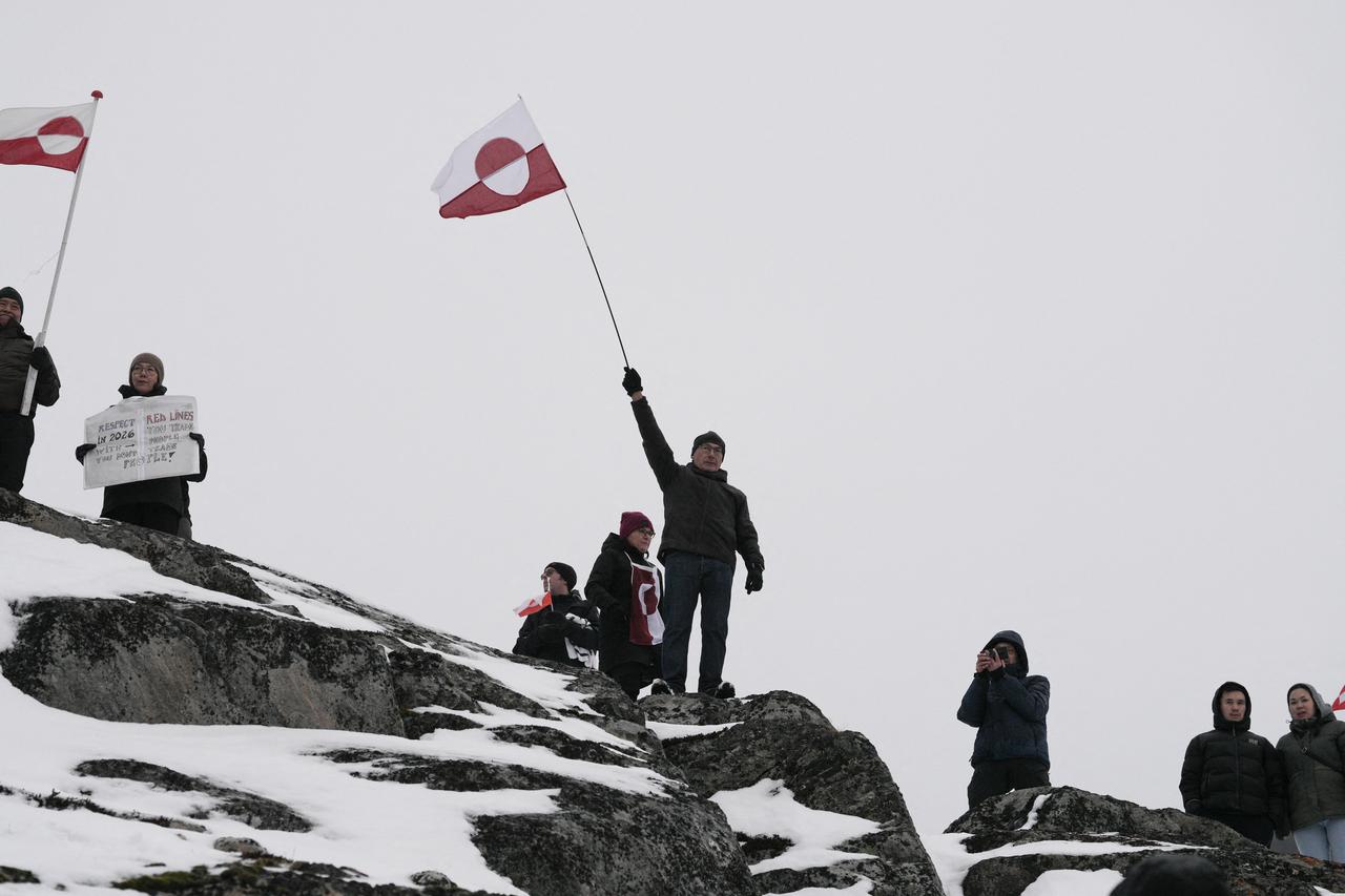 People wave Greenlandic flags as they take part in a demonstration to protest against the US President's plans to take Greenland, in Nuuk, Greenland, on January 17, 2026. (AFP Photo)