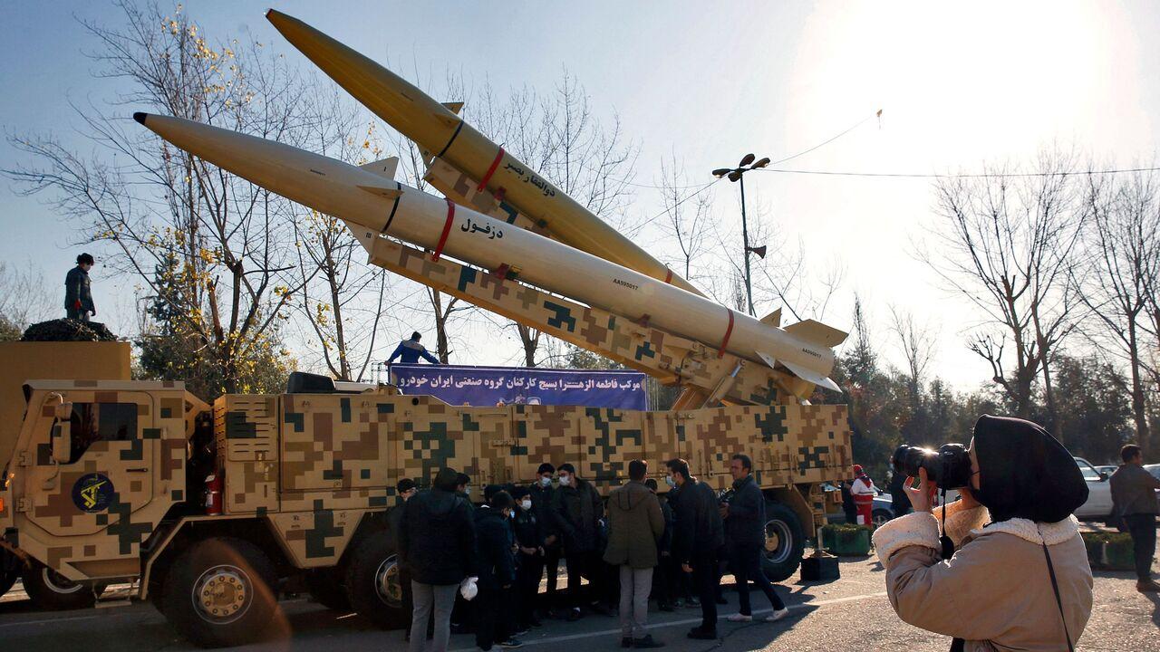 Iranian woman takes a picture of Zolfaghar-Basir and Dezful missiles displayed at Mosallah mosque on the occasion of second anniversary of an Iran missile attack at a US military base in Iraq, January 7, 2022. (AFP Photo)