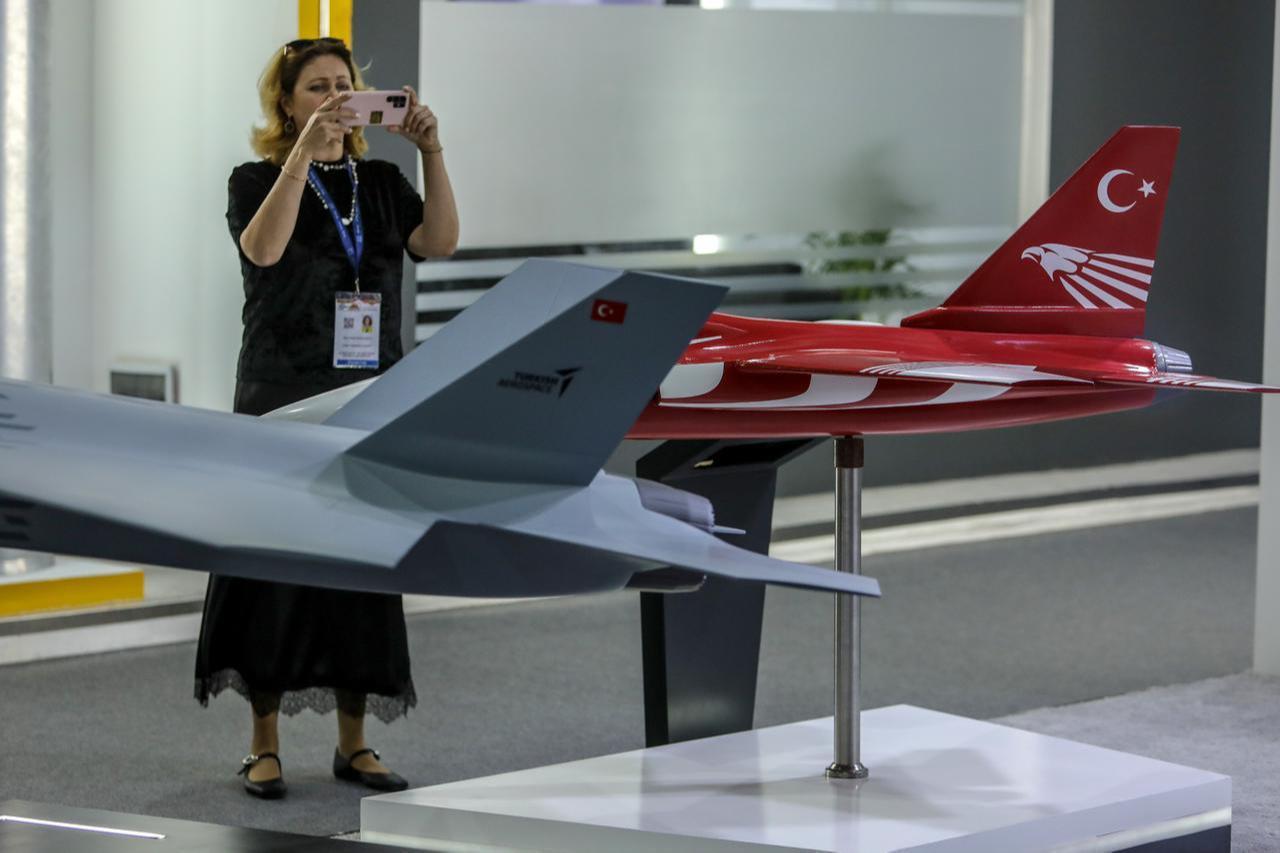 People visit the TAI stand, with the Hurjet and KAAN models displayed, at the 4th EDEX 2025 Egypt Defense Expo in Cairo, the capital of Egypt, Dec. 2, 2025. (AA Photo)