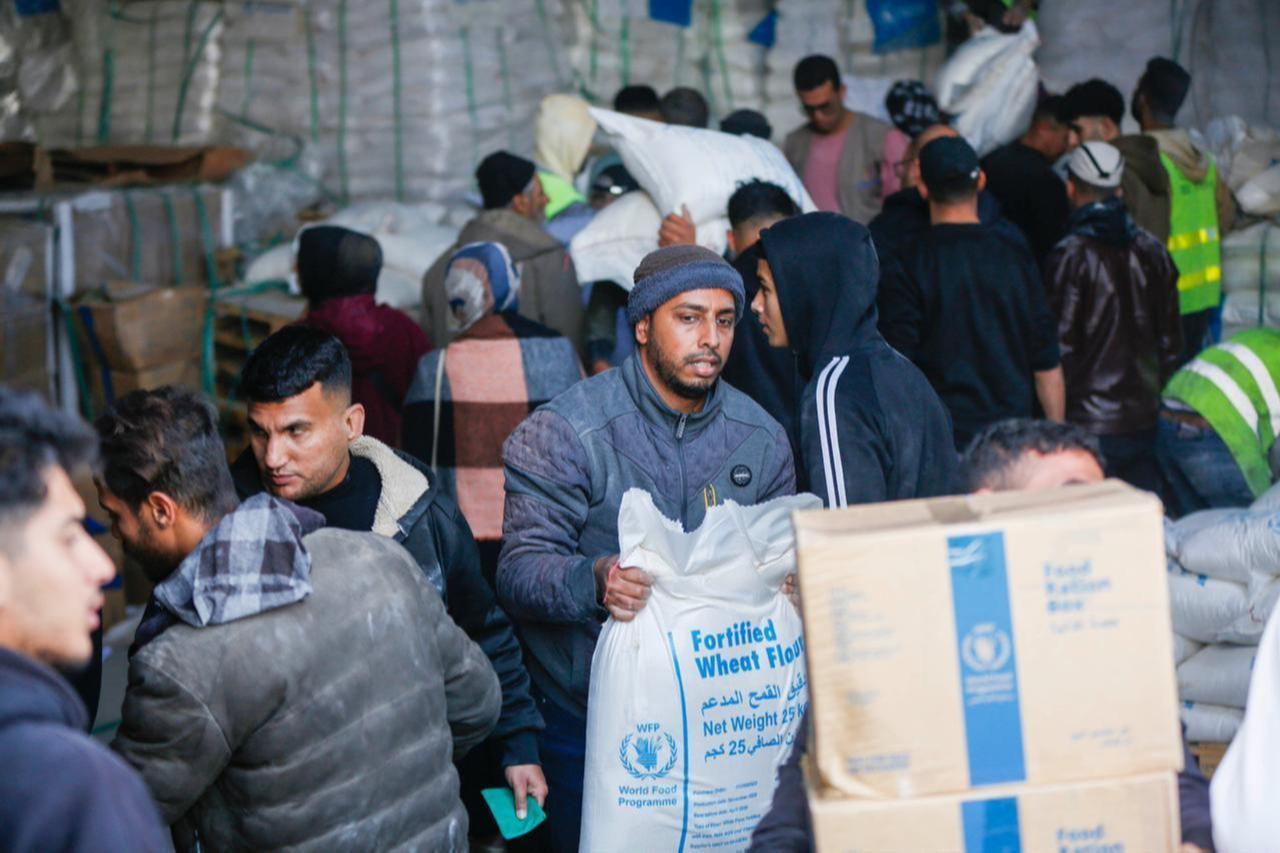Displaced Palestinians, including children, receive flour and food packages distributed by the United Nations World Food Programme (WFP) in the Zawaida area of Deir al-Balah in the central Gaza Strip on Jan. 07, 2026. (AA Photo)
