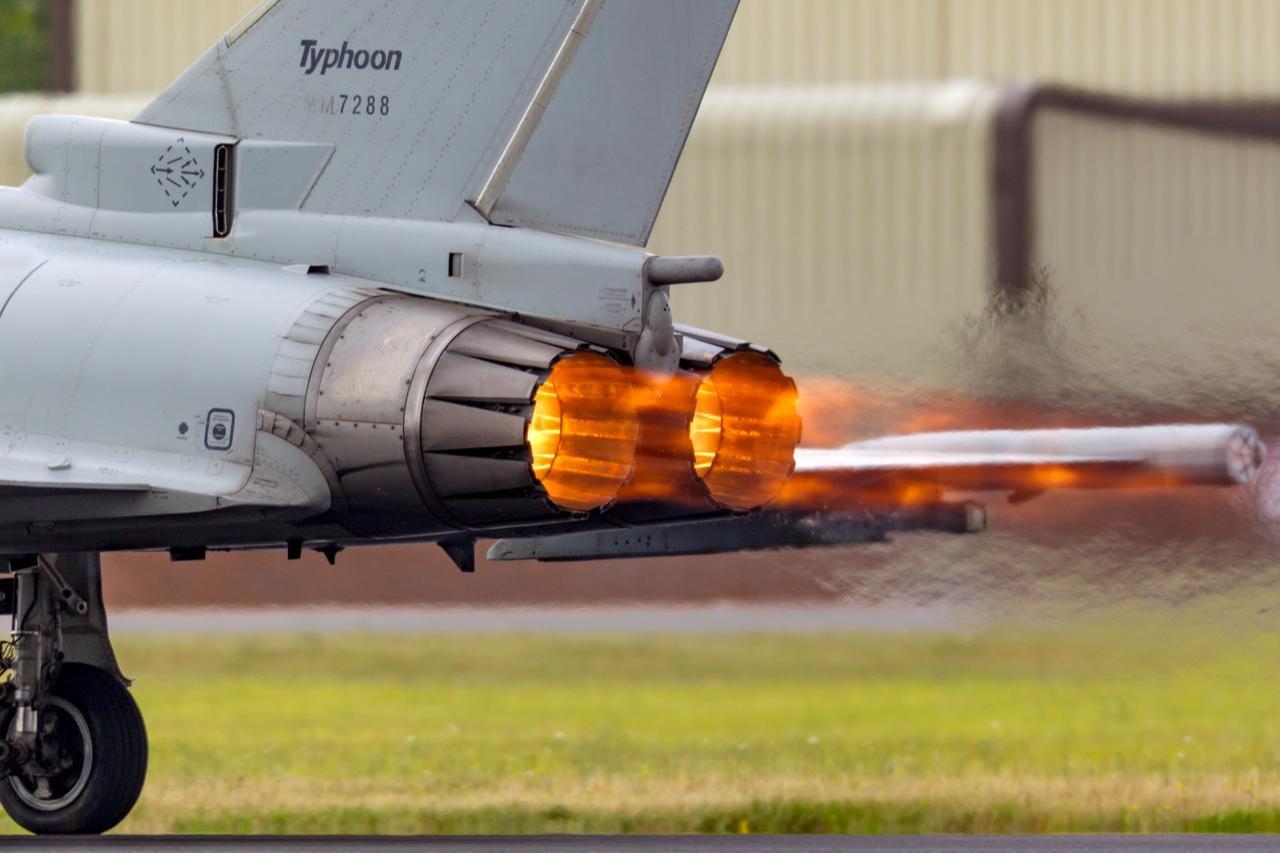 Glowing hot afterburners of Italian Air Force Eurofighter Typhoon aircraft as it accelerates down the runway at RAF Fairford, Gloucestershire, UK, July 14, 2014. (Adobe Stock Photo)