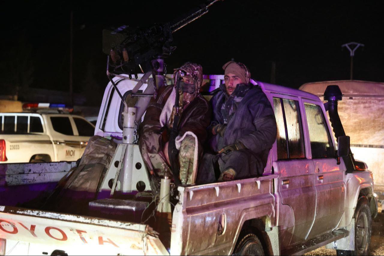 Syrian government forces escort SDF members as they withdraw from al-Aqtan prison on the outskirts of the northeastern city of Raqqa, bound for Ayn al-Arab, Syria, on January 23, 2026. (AFP Photo)
