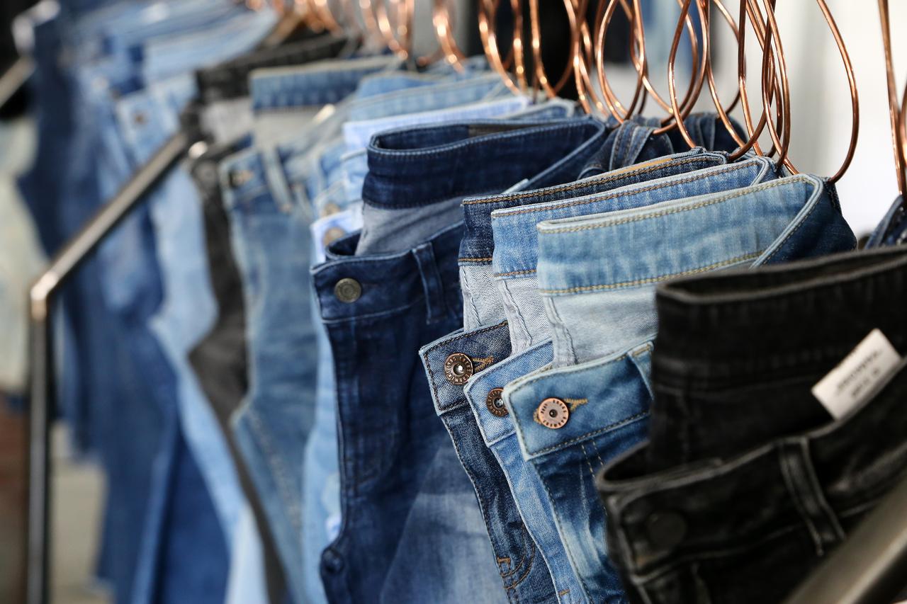 Various styles of denim jeans hang on display in a store in Türkiye. (Adobe Stock Photo)
