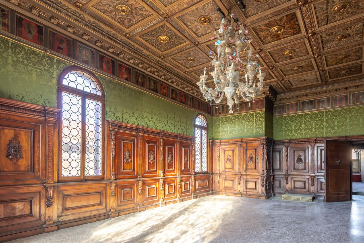 A wood paneled salon with coffered ceiling and glass chandelier inside Ca’ Dario in Venice, Italy, accessed on January 25, 2026. (Courtesy of Christie’s Real Estate)