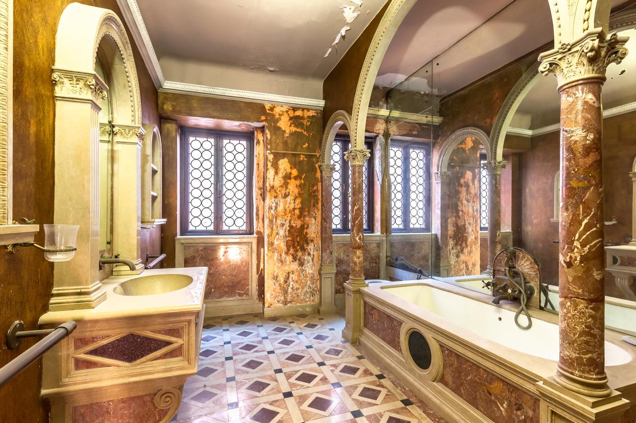 A marble clad bathroom with arched columns and decorative stonework inside Ca’ Dario in Venice, Italy, accessed on January 25, 2026. (Courtesy of Christie’s Real Estate)