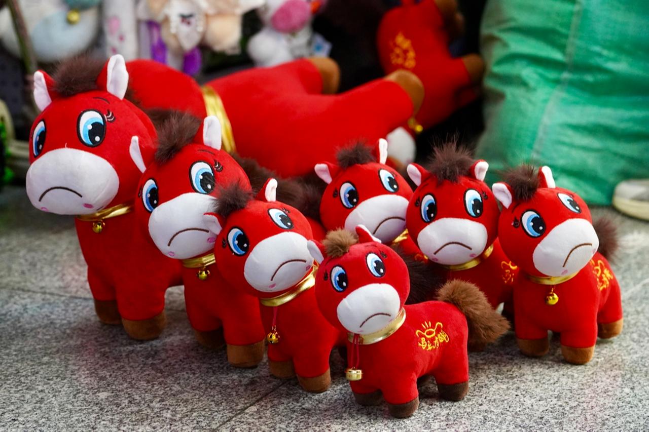A red horse doll that has gone viral on Chinese social media after a manufacturing error gave it an unusually sad expression ( Photo via X / @investing_china )