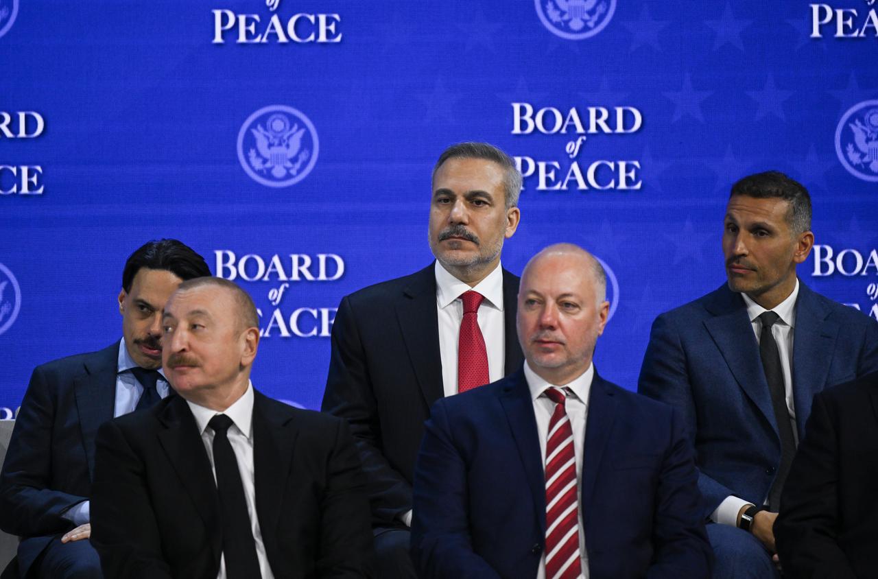 Azerbaijani President Ilham Aliyev (L) and Turkish Foreign Minister Hakan Fidan (back C) attend the signing ceremony of the Peace Charter for Gaza as part of the 56th World Economic Forum in Davos, Switzerland on Jan. 22, 2026. (AA Photo)
