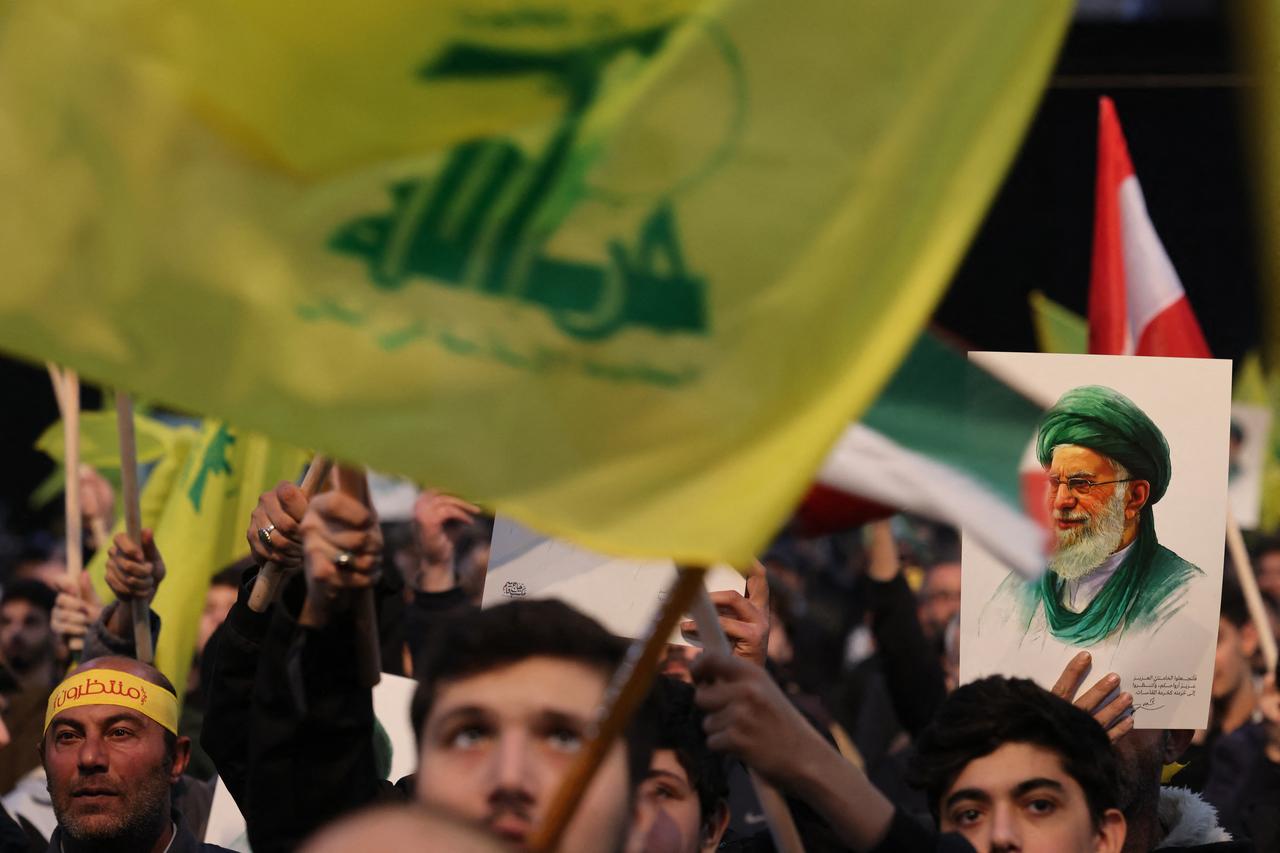 A supporter of Hezbollah holds a portrait of Iran's Supreme Leader Ayatollah Ali Khamenei during a rally to show their solidarity with Iran, in the southern suburb of Beirut, Lebanon on January 26, 2026. (AFP Photo)
