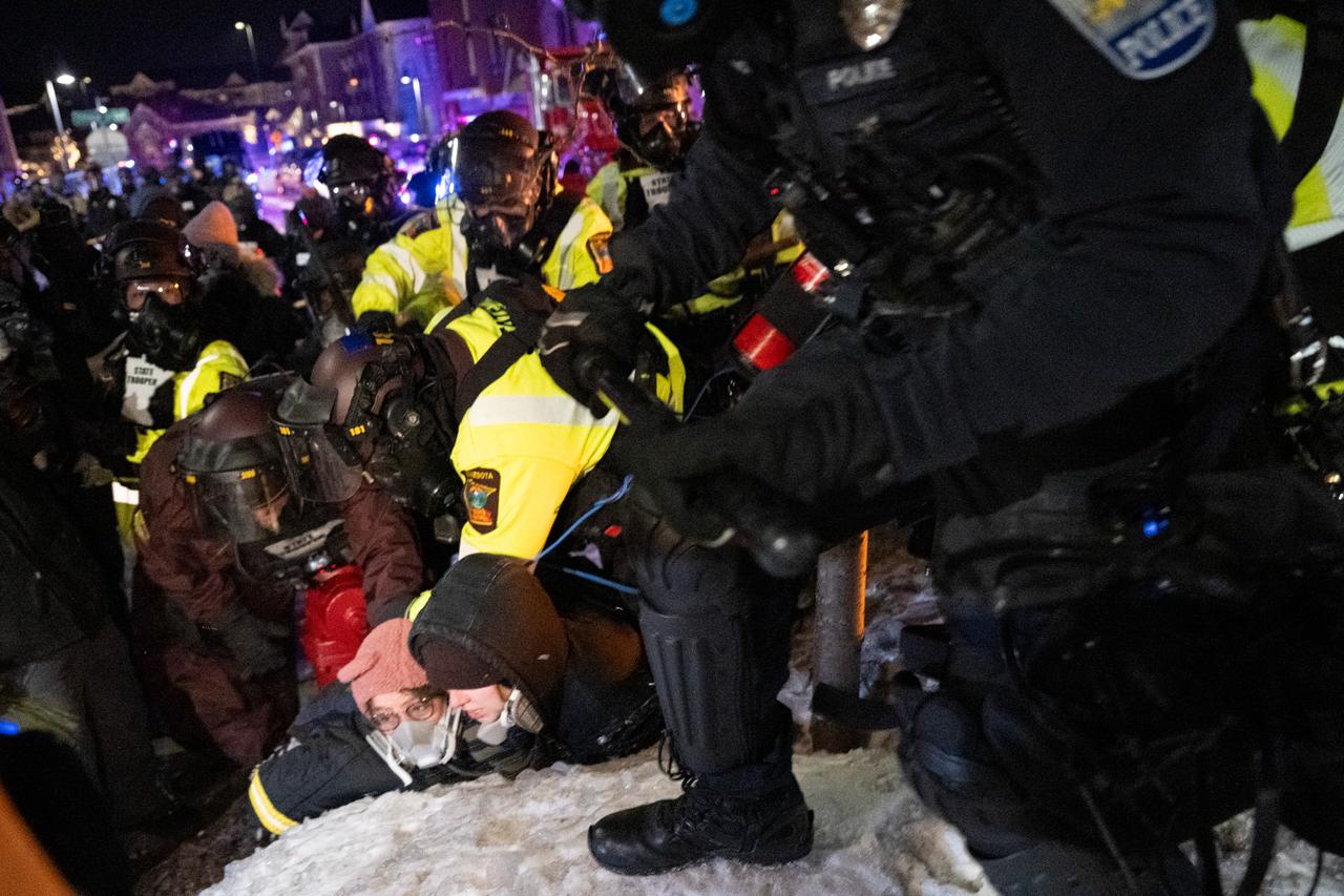 Minnesota State Troopers and Minneapolis police arrest two protestors who had gathered with others for a “Goodbye Bovino Noise Demo” rally where protesters believe Gregory Bovino to be staying, Minneapolis, United States, January 26, 2026. (AFP Photo)