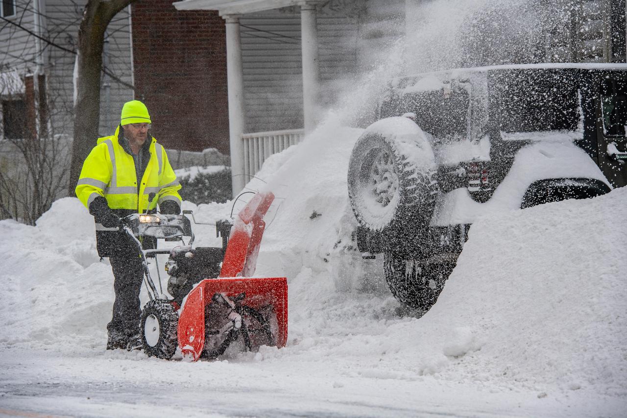 A person uses a snowblower to remove snow from their driveway in Winthrop, Massachusetts, January 26, 2026. (AFP Photo)