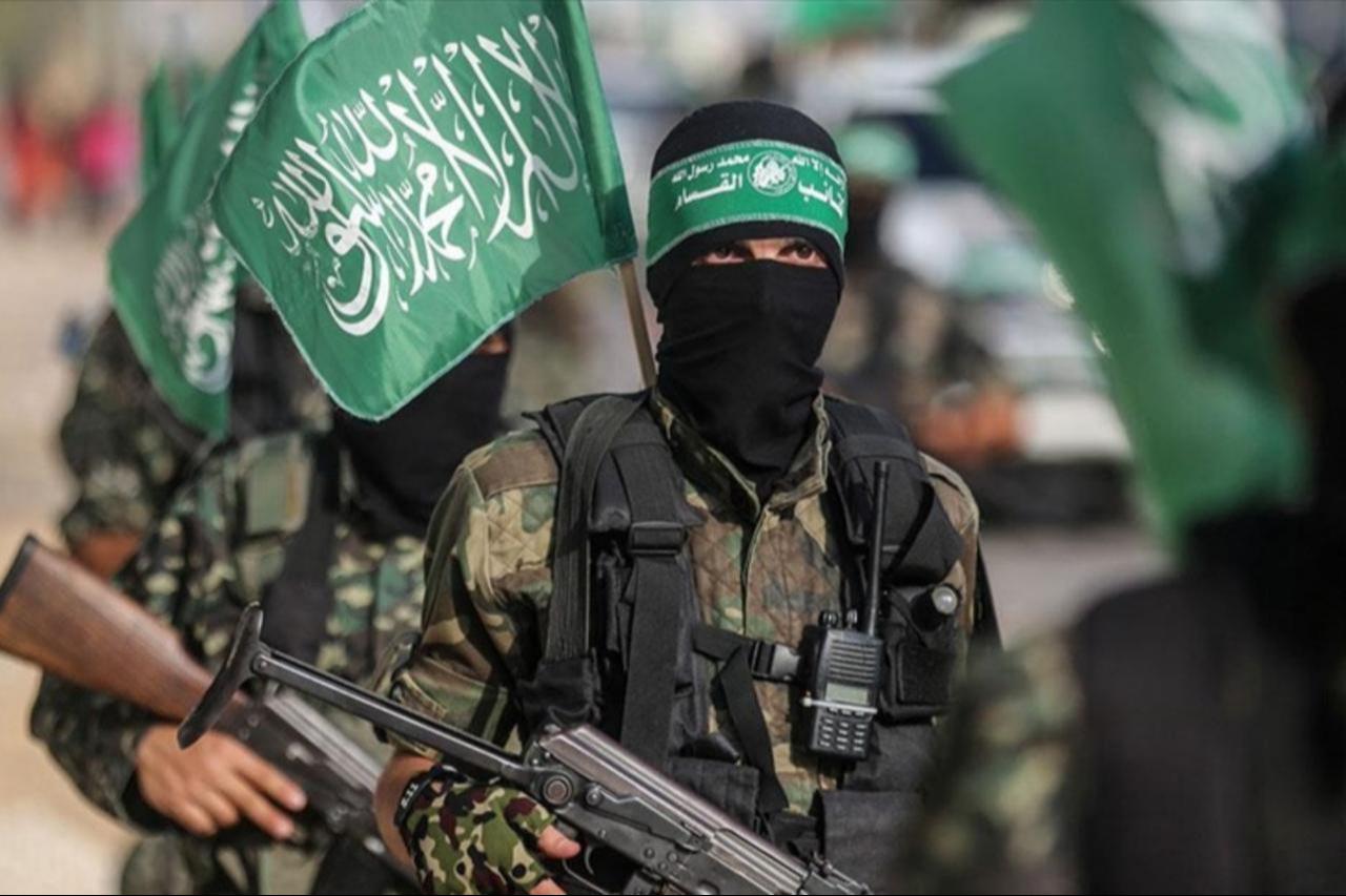 Hamas members march during a military display, carrying flags and firearms in Gaza City, Gaza, date and time undisclosed. (AA photo )