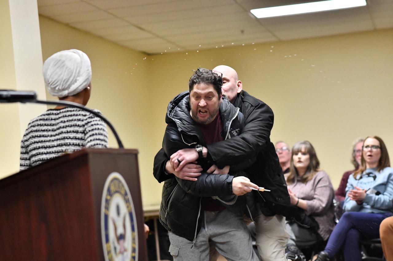 A man is tackled after spraying an unknown substance at US Representative Ilhan Omar (D-MN) (L) during a town hall she was hosting in Minneapolis, Minnesota, January 27, 2026. (AFP Photo)