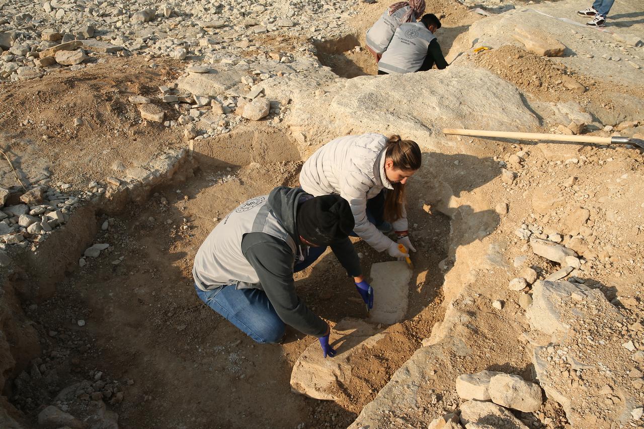 Archaeologists work inside an excavation pit along the shoreline of the Ataturk Dam reservoir, where structures dating back around 11,000 years have emerged in Adiyaman, southeastern Türkiye, Jan. 27, 2026. (AA Photo)