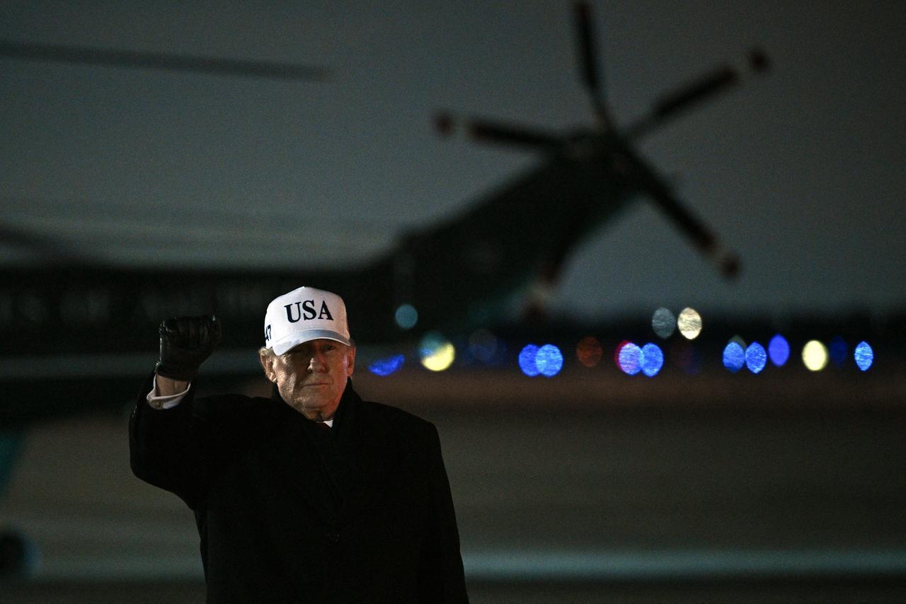 US President Donald Trump raises a fist as he arrives at Joint Base Andrews, Maryland, on January 27, 2026. (AFP Photo)