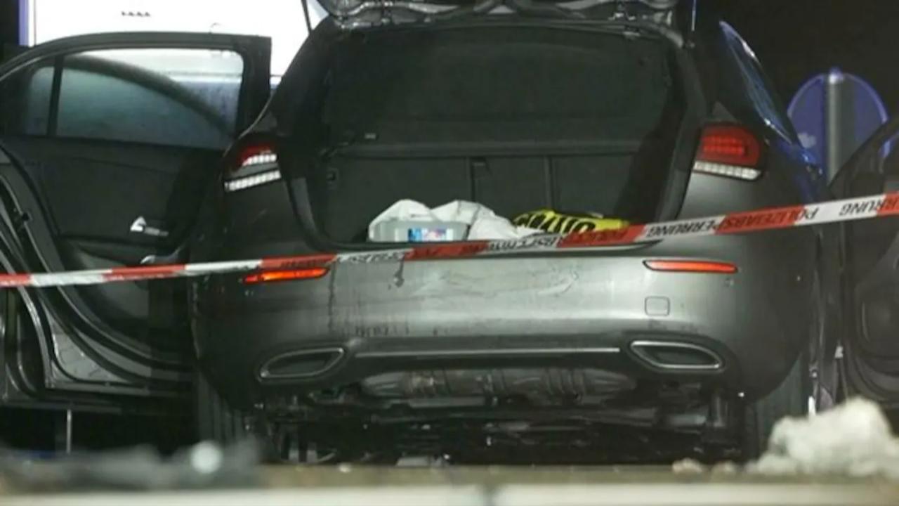Vehicles and German police officers stand on a street in Weißenburg, Germany after a chase. (Photo via dpa)