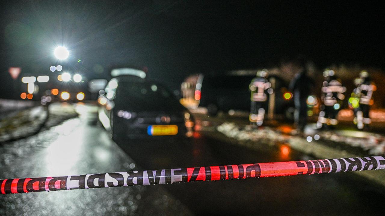 Vehicles and police officers are stopped on a street in Weißenburg after a chase. (Photo via dpa)