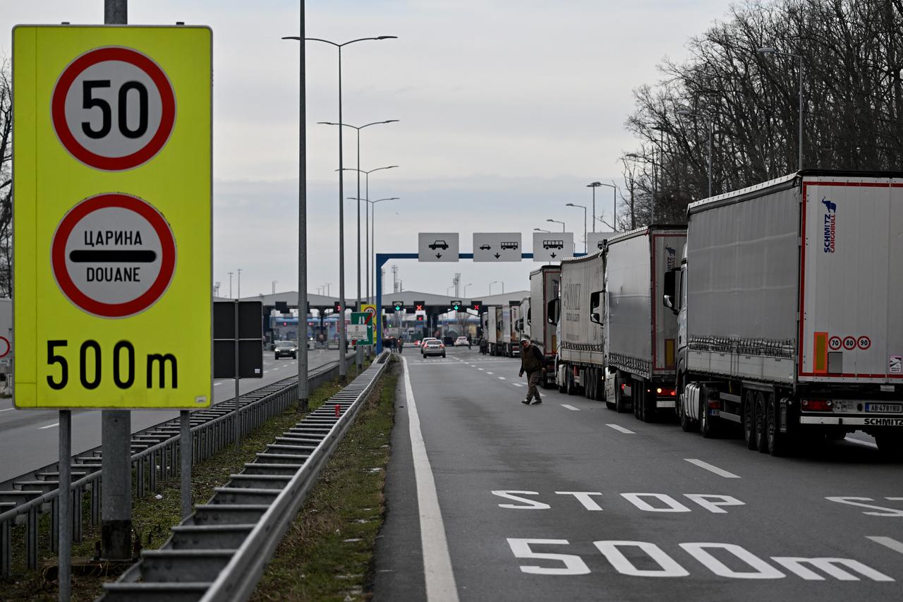 A truck driver crosses a road at the Batrovci border crossing between Serbia and Croatia on January 26, 2026. (AFP Photo)