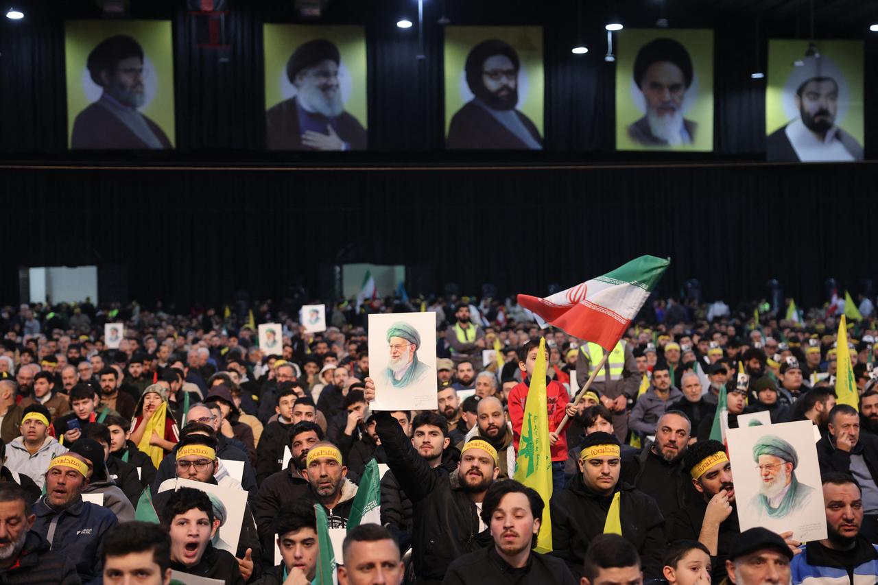 Hezbollah supporters hold portraits of Iran's Supreme Leader Ali Khamenei during a rally to show their solidarity with Iran, in the southern suburb of Beirut on January 26, 2026. (AFP Photo)