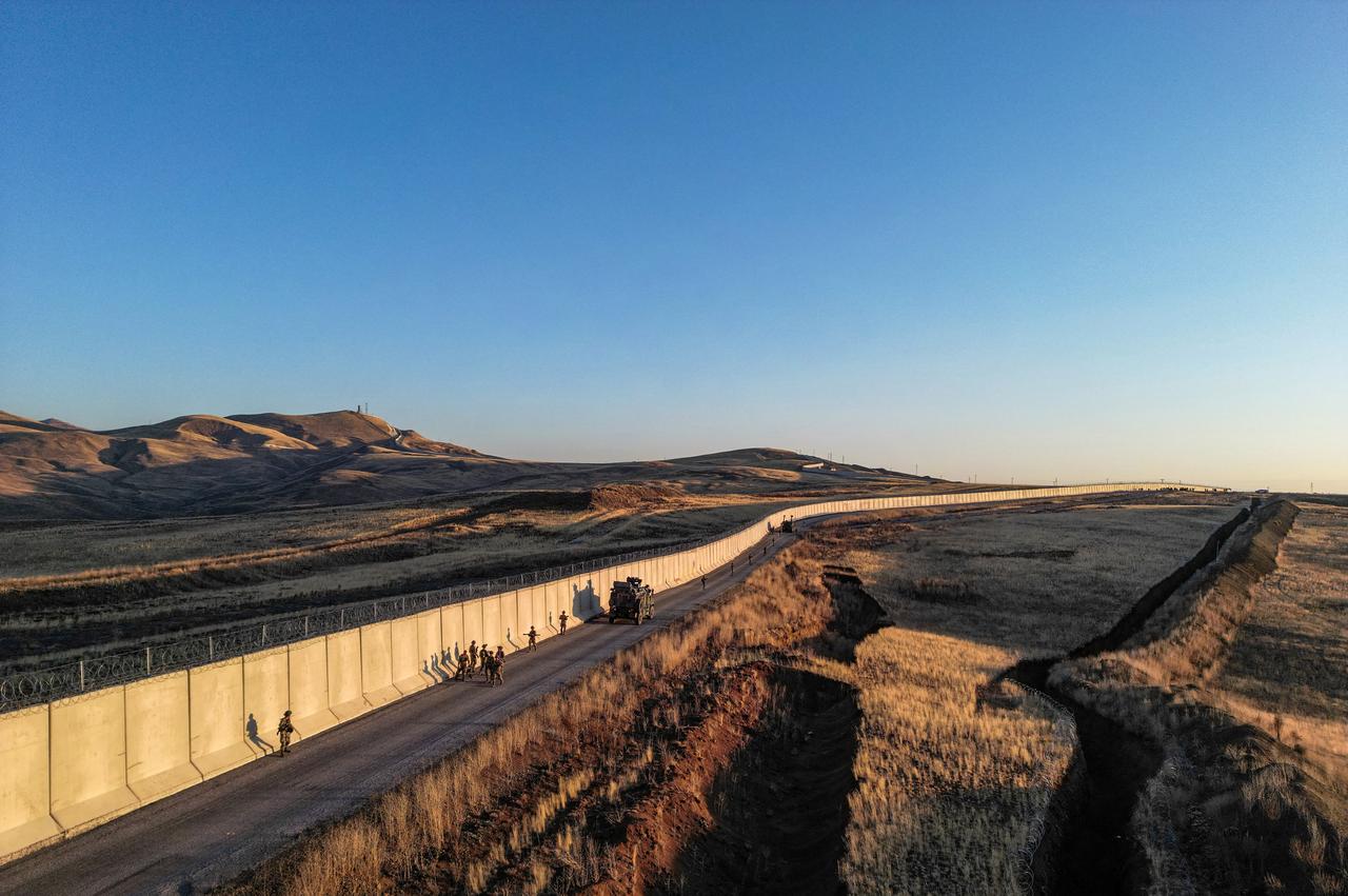 An aerial view shows the border wall between Türkiye and Iran, with Turkish soldiers patrolling in the Van Province, eastern Türkiye, on November 1, 2024. (AFP Photo)