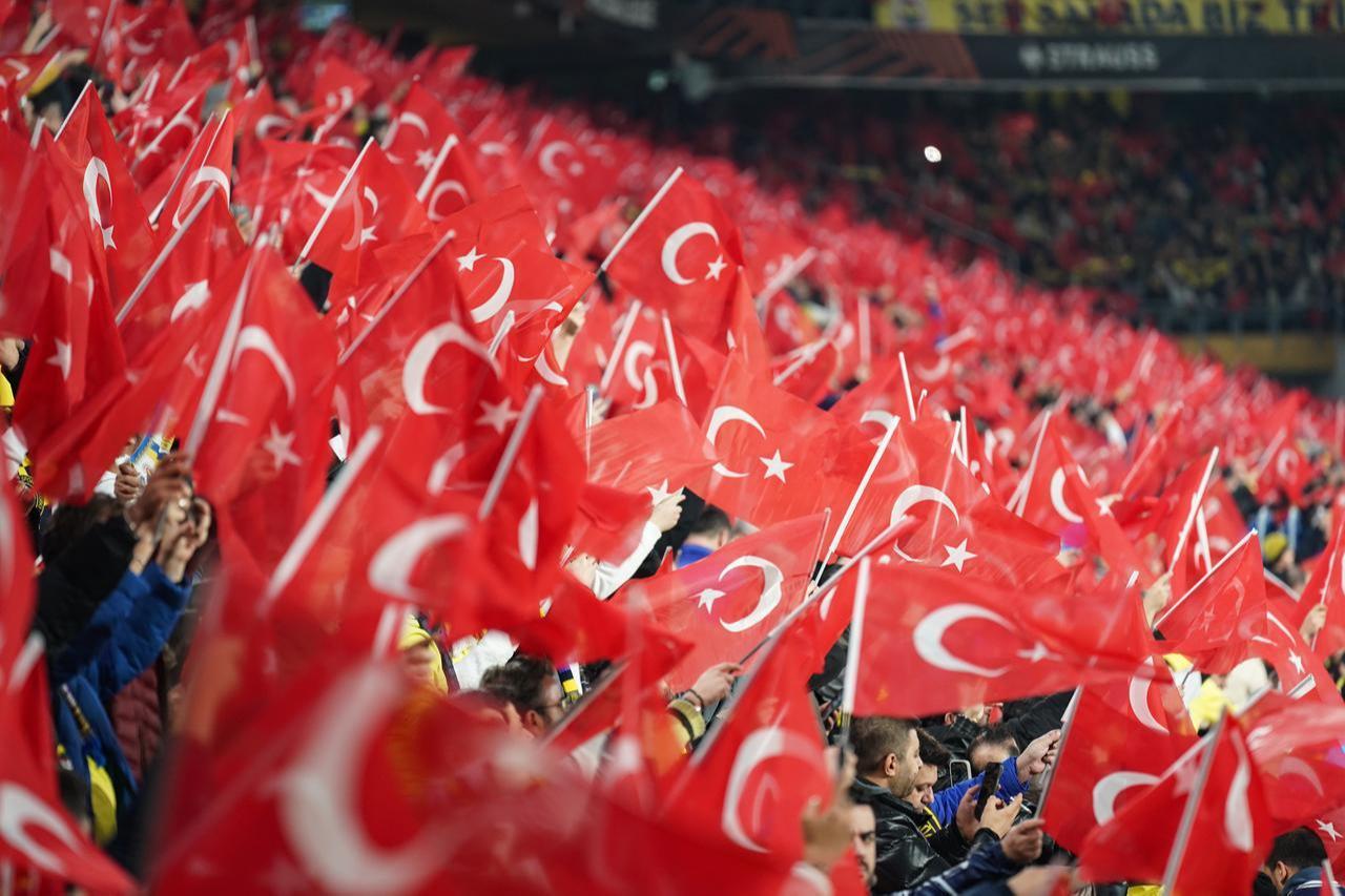Fans wave Turkish flags as they support their team during the UEFA Europa League match between Fenerbahce and Aston Villa at Chobani Stadium in Istanbul, Jan. 22, 2026. (AA Photo)