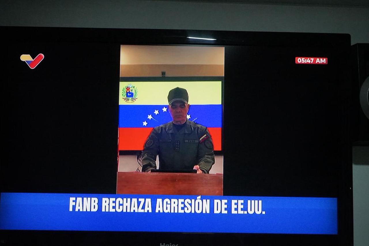 A person watches a public television screen broadcasting Venezuelan Defense Minister Vladimir Padrino's address to the nation in Caracas, Venezuela, Jan. 3, 2026. (AA Photo)