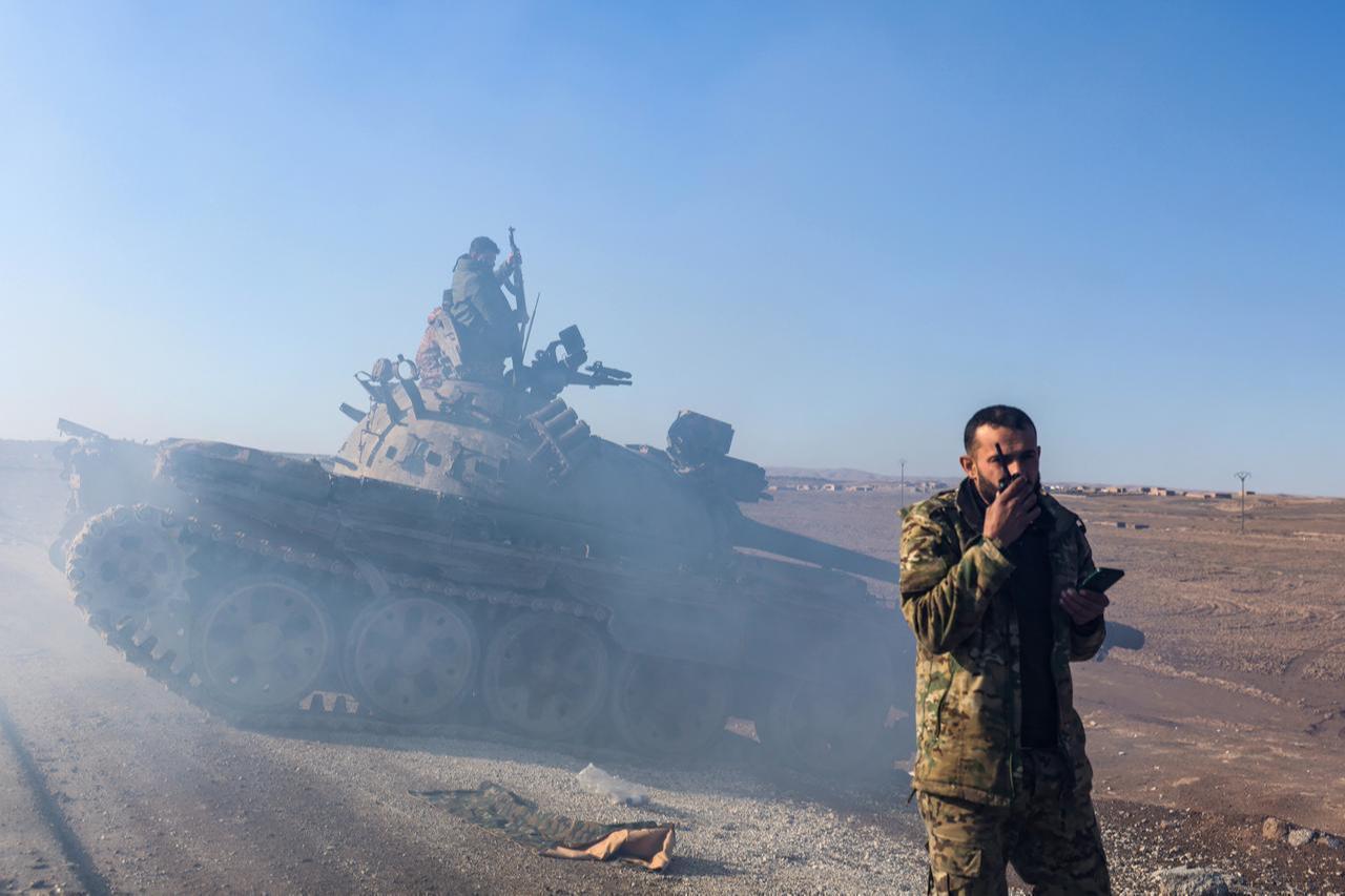 A tank drives behind a soldier as Syrian government forces make their way to the city of Hasakah in northeastern Syria on January 20, 2026. (AFP Photo)