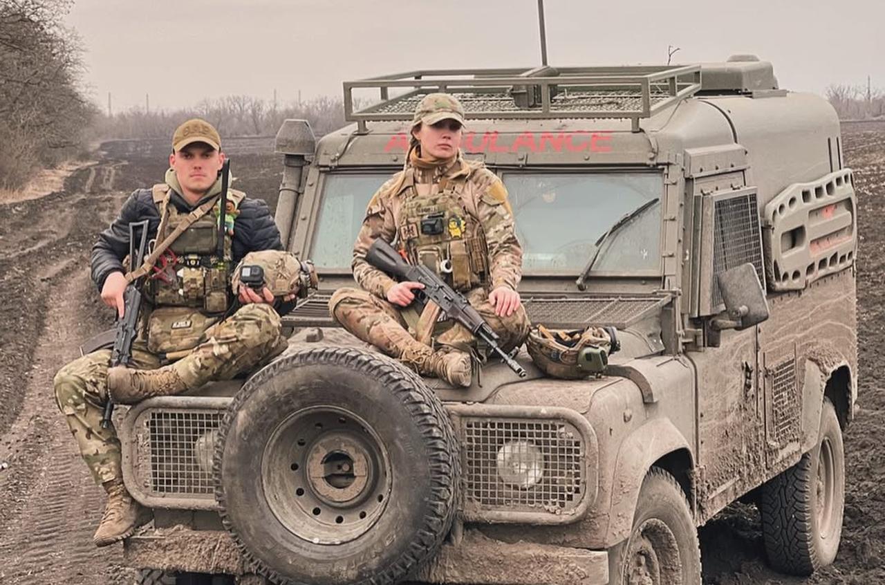Viktoriia Honcharuk (R) and a fellow soldier (L) pose on an armored ambulance vehicle during a pause in operations in eastern Ukraine. (Photo via Instagram/victoria__honcharuk)