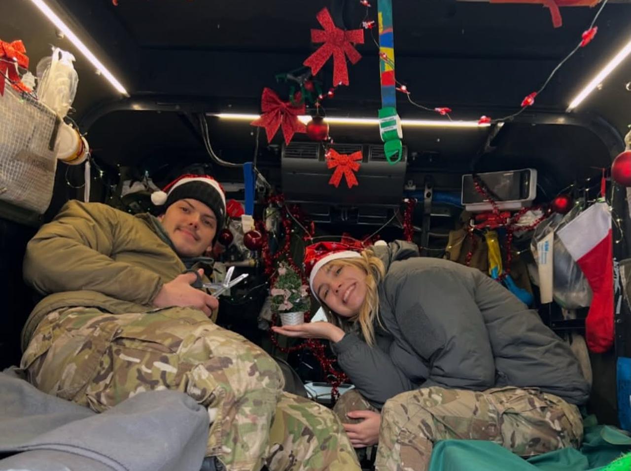 Viktoriia Honcharuk and Ukrainian combat medic rest briefly inside a medical evacuation vehicle decorated for the holiday season. (Photo via Instagram/victoria__honcharuk)