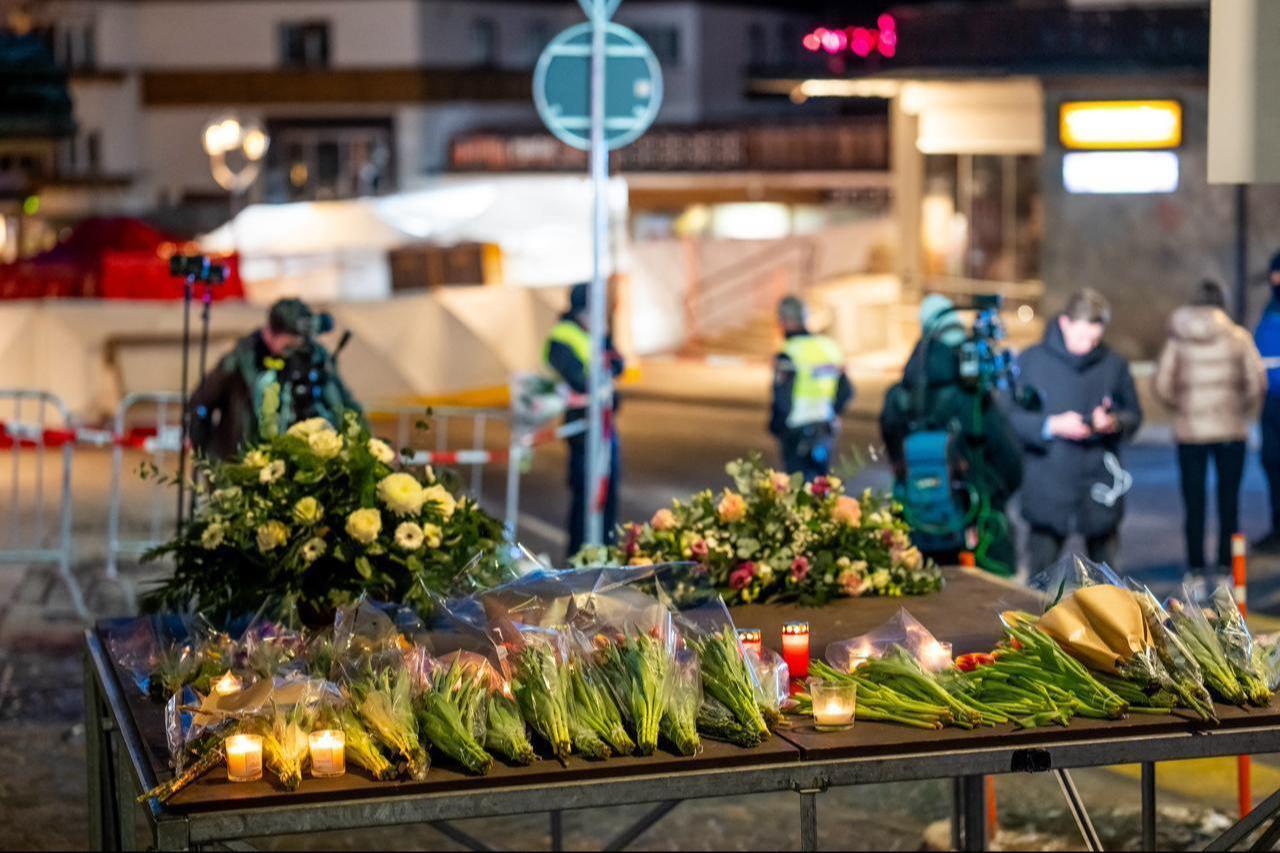 This photograph shows flowers and candles laid near the site where a fire ripped through a crowded bar during New Years Eve celebrations in the Alpine ski resort town of Crans-Montana, Jan. 1, 2026. (AFP Photo)