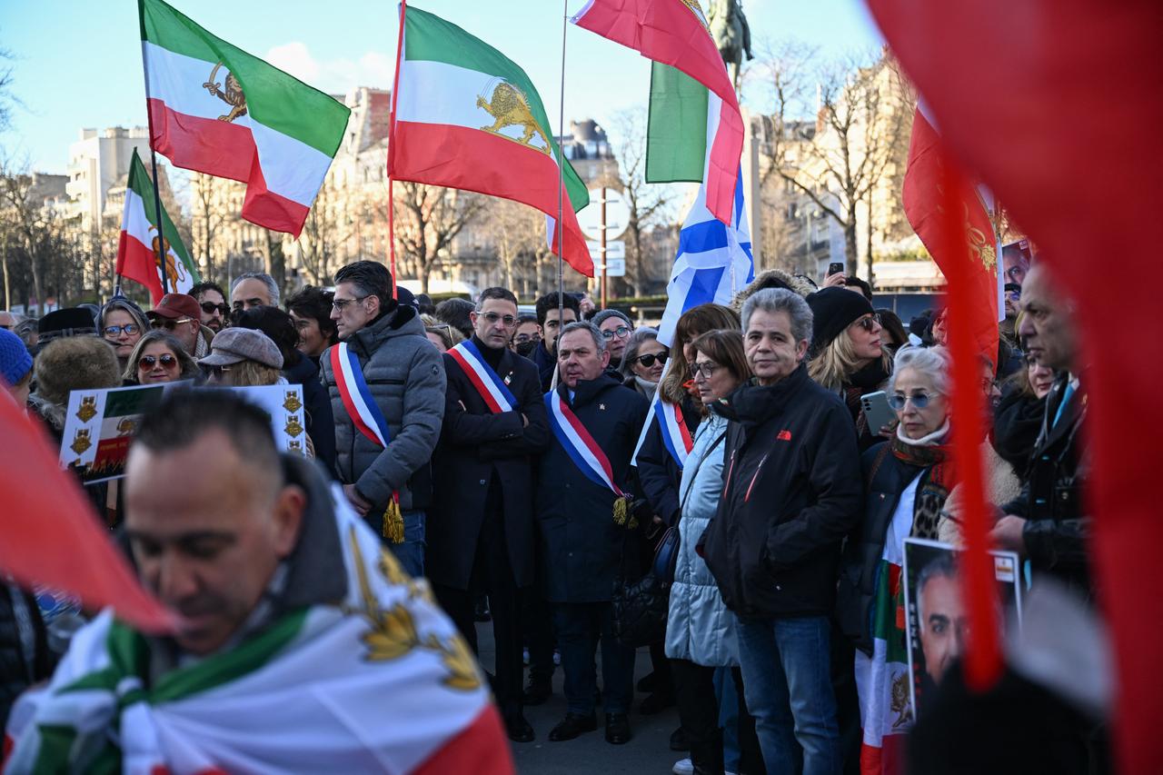 Mayor of the 16th arrondissement of Paris Jeremy Redler (CL), member of the City Council of Courbevoie Arash Derambarsh (C) and French Senator Francis Szpiner (CR) attend a demonstration against the Iranian regime's crackdown on protests, in central Paris, on Jan. 4, 2026. (AFP Photo)