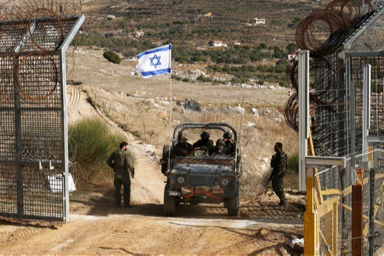 An Israeli military vehicle crosses the fence as they return from buffer zone with Syria, near Druze village of Majdal Shams in Israel-annexed Golan Heights, Dec. 10, 2024. (AFP Photo)