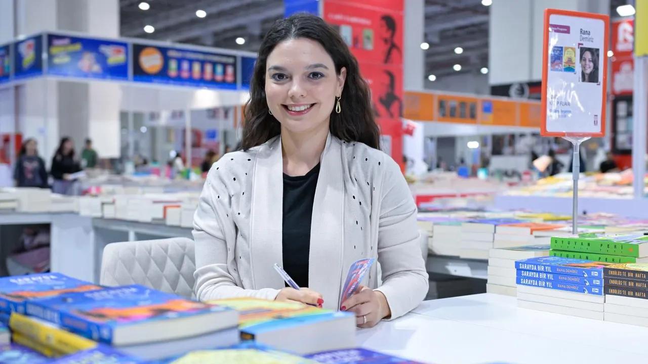 Art historian Rana Demiriz signs copies of her books during a literary event, reflecting her work on Ottoman miniature painting as a visual record of history. (Photo via Türkiye daily)