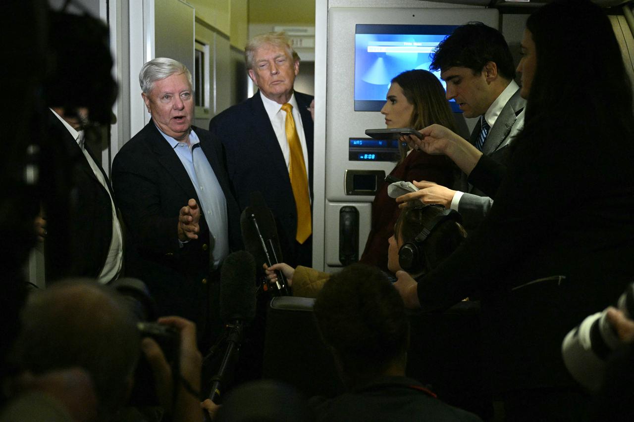 US senator Lindsey Graham (L), Republican of South Carolina, accompanied by President Donald Trump, speaks with reporters aboard Air Force One on their way back to Washington, DC, Jan. 4, 2026. (AFP Photo)