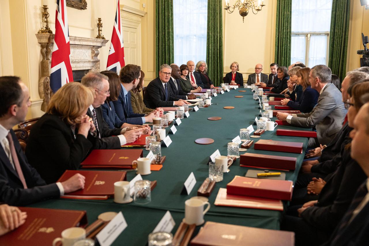 Britain's Prime Minister Keir Starmer (centre left) speaks to members of his political Cabinet at the start of the first cabinet meeting of the new year inside 10 Downing Street in central London on January 6, 2026. (AFP Photo)