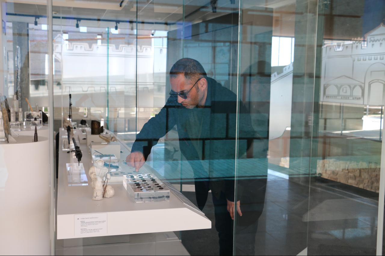 A museum expert views historical artifacts displayed as part of the modern museum exhibition at Seddulbahir Castle in Eceabat, Canakkale, Türkiye, Jan. 6, 2026. (AA Photo)