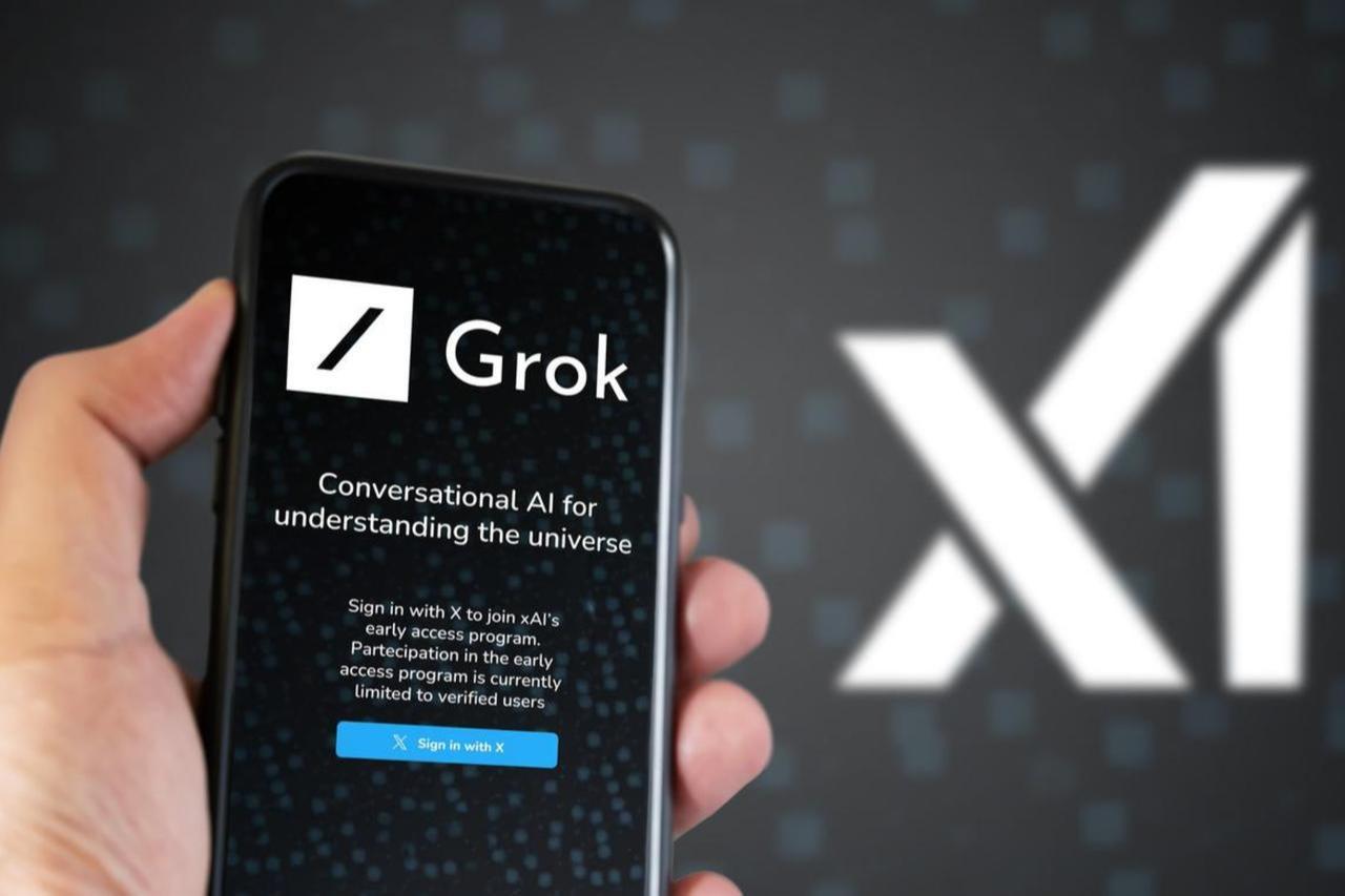 Photo illustration shows a person holding a smartphone displaying the Grok chatbot interface, with xAI companys logo in the background, accessed on Jan. 7, 2025. (Adobe Stock Photo)