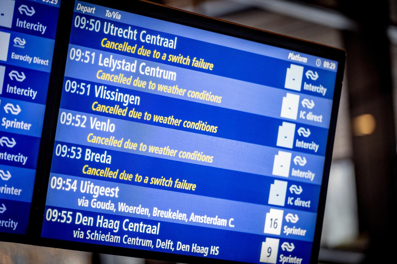 This photograph shows a screen indicating cancellations as the train service is currently suspended due to heavy snowfalls at Rotterdam Central Station, The Netherlands, on Jan. 7, 2026. (AFP Photo)