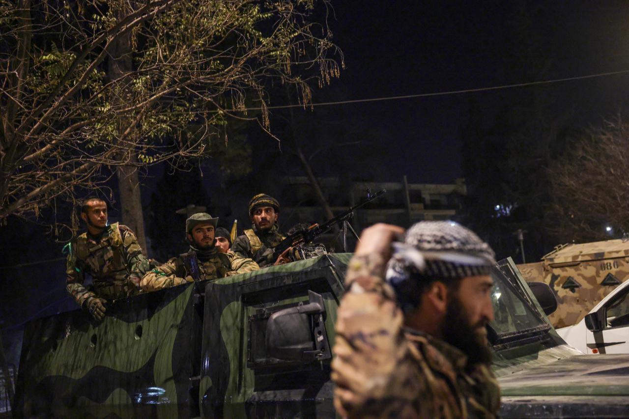 Syrian army soldiers ride atop armored vehicles during operations in the Ashrafieh neighborhood of Aleppo, Syria, January 8, 2026. (AA Photo)