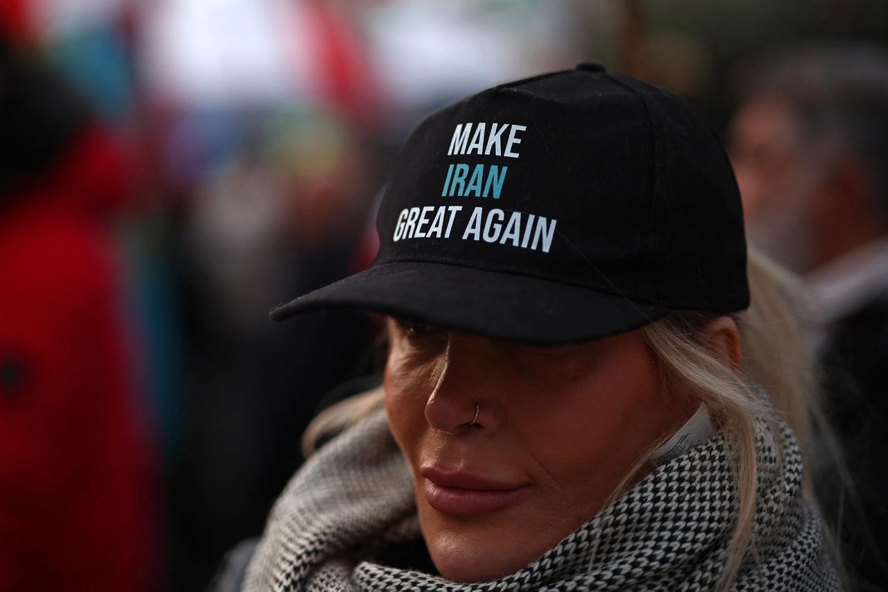 A person wearing a Make Iran Great Again cap joins anti-Iranian regime protesters gathering outside the Iranian Embassy, central London, on Jan. 9, 2026. (AFP Photo)