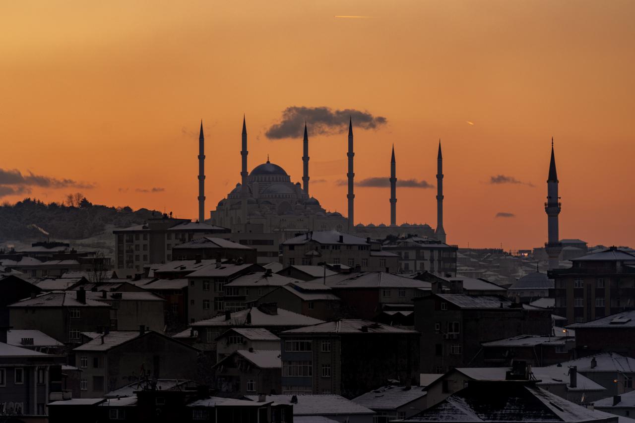 A sunset unfolds over Camlica Mosque as snowfall continues to affect parts of Istanbul, Türkiye, on January 1, 2026.  (AA Photo)