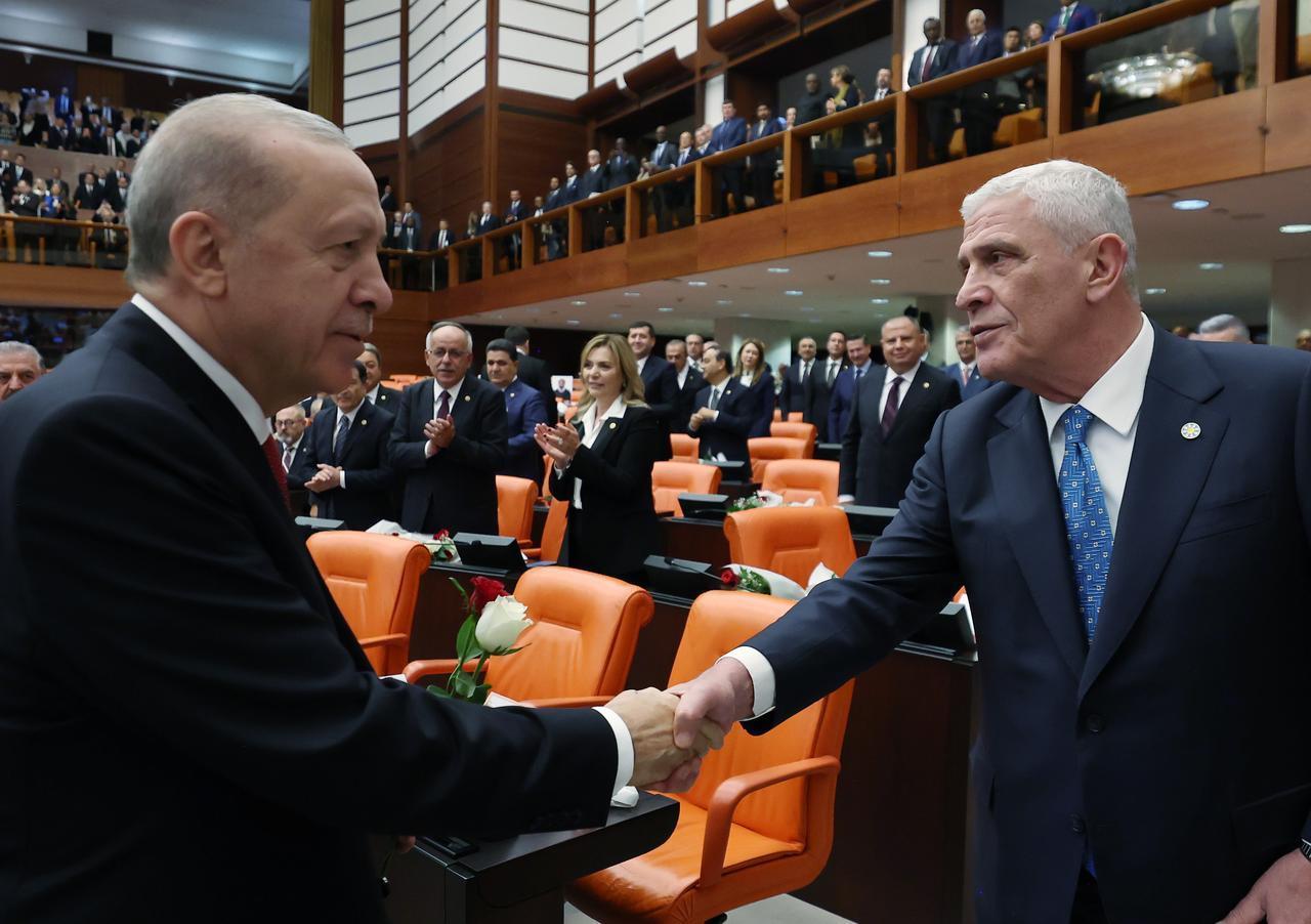 President Recep Tayyip Erdogan (L) shakes hands with IYI Party Chairman Musavat Dervisoglu (R) following his address to the General Assembly in Ankara, Türkiye, Oct. 1, 2026. (Turkish Presidency/Murat Cetinmuhurdar/HO)
