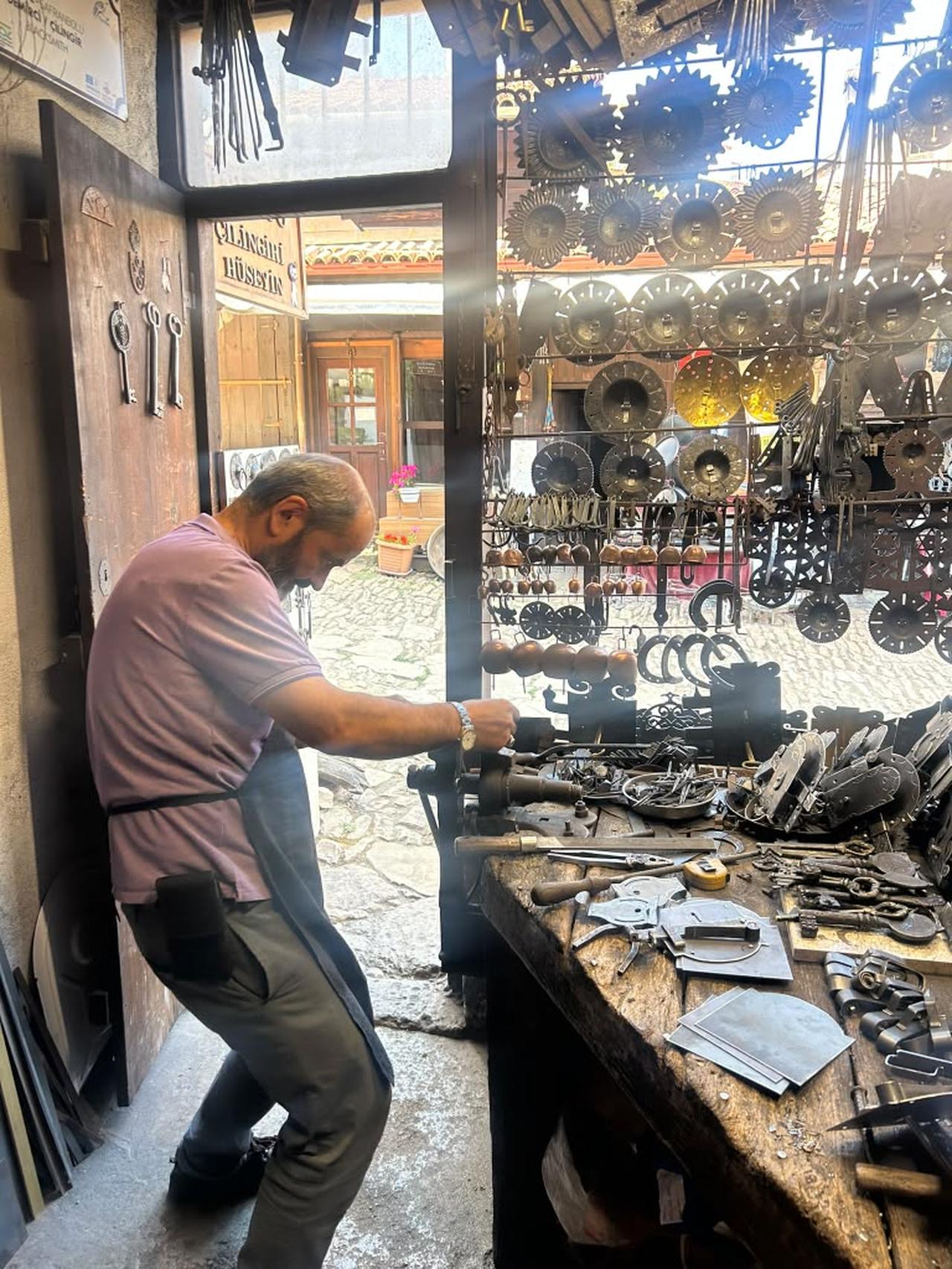 The interior of Huseyin Sahin Ozdemir’s workshop is lined with handmade locks, keys and metal ornaments produced using traditional techniques. (Photo by Sophia K. Fullerton)