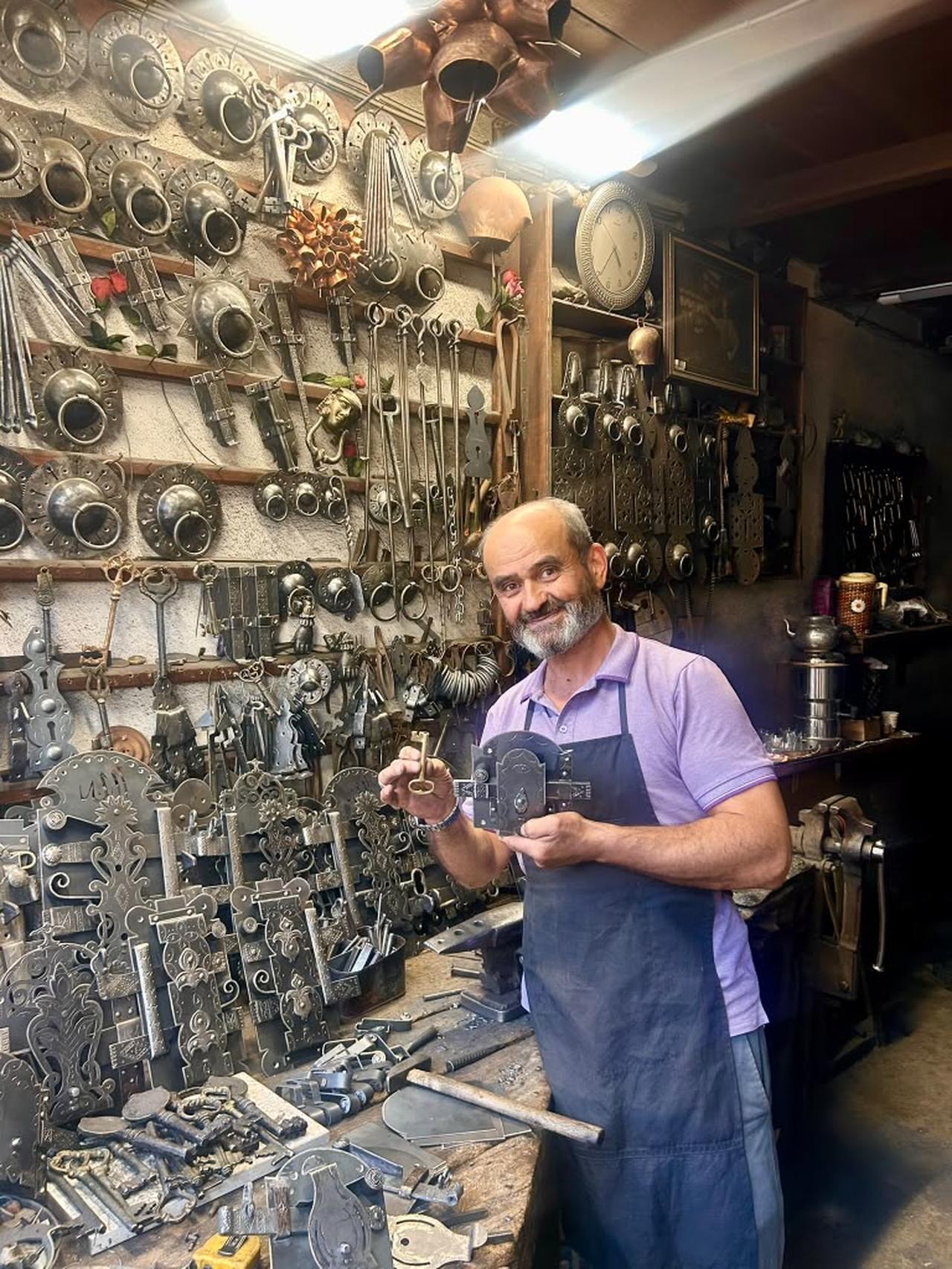Huseyin Sahin Ozdemir displays one of his handmade Ottoman-style locks and its key inside his workshop in Safranbolu, Karabuk, Türkiye. (Photo by Sophia K. Fullerton)