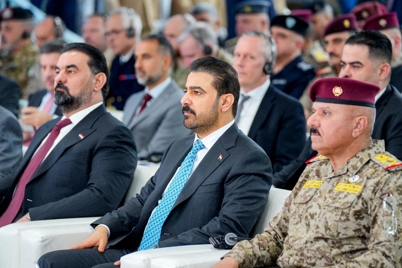 This handout picture released by the Iraqi Prime Minister's office shows Prime Minister Ali al-Zaidi (C) attending a ceremony marking "Sovereignty Day", the end of presence of the forces of the US-led coalition against the Islamic State in Iraq, in Baghdad on September 30, 2026. (Photo by Iraq's Prime Minister Media Office / AFP)