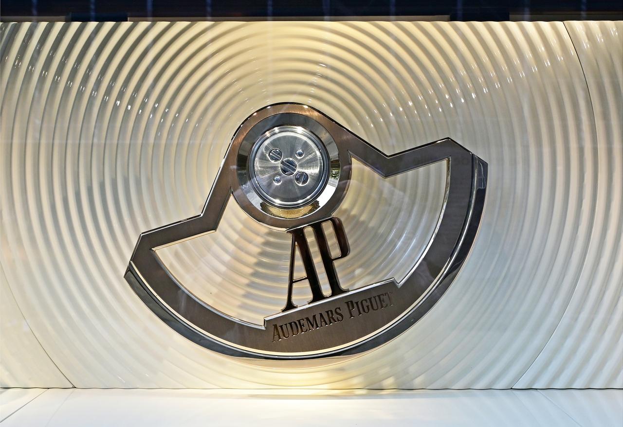 The Audemars Piguet logo is displayed at a watch industry venue, reflecting the global presence of luxury watchmaking. (Adobe Stock Photo)