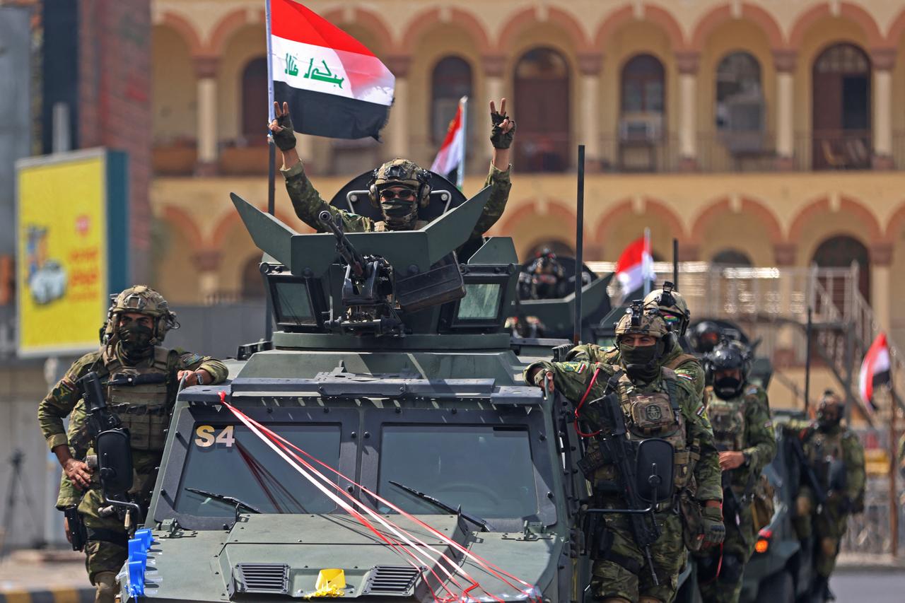 A member of the Iraqi security forces, flashes the victory sign during a military parade marking the withdrawal of the US-led coalition from Iraq, in Baghdad on September 30, 2026. (AFP photo)