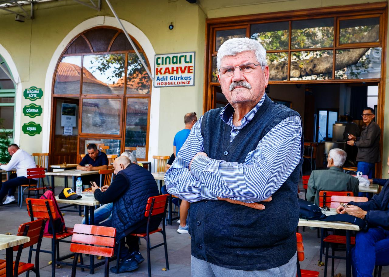 Adil Gurkas, 78, poses outside Cinarli Kahve in Bergama, Izmir, where he has maintained a coffeehouse tradition dating back to 1979. (AA Photo)