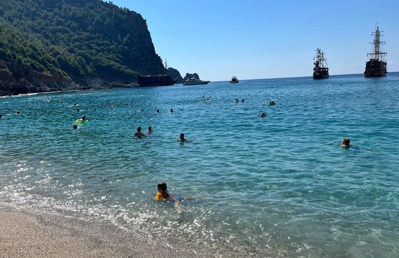 Tourists swim in the Mediterranean Sea off Alanya, Antalya, as warm October weather continues to draw visitors to the coast, Türkiye, Oct. 8, 2026. (IHA Photo)
